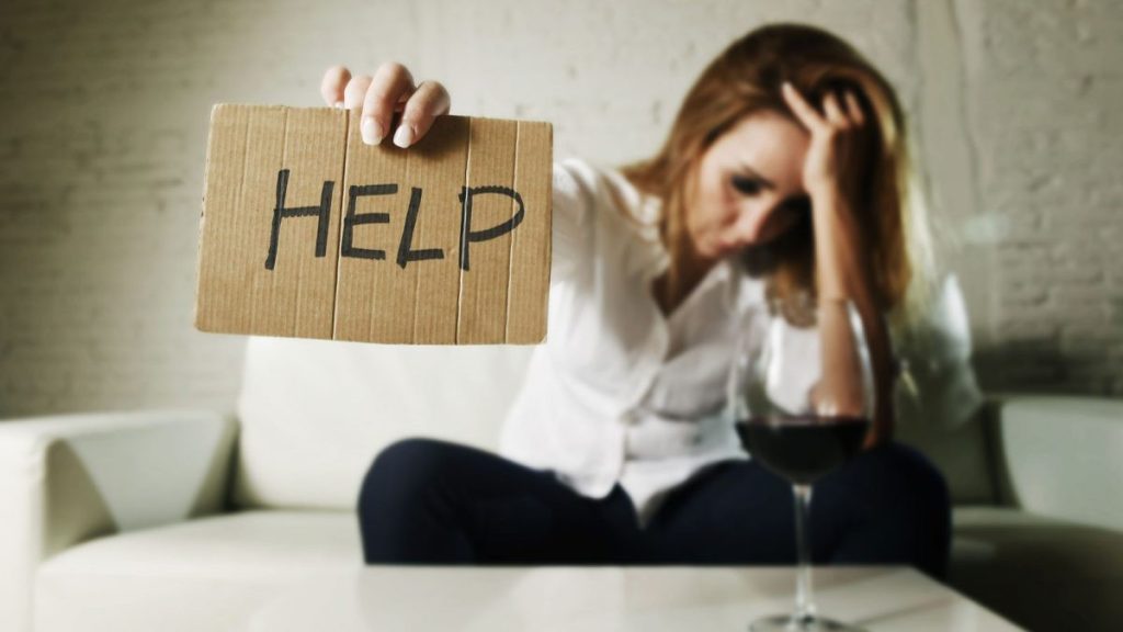 woman holding up sign for help
