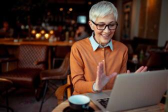 Smiling person in video call for addiction treatment at home support.