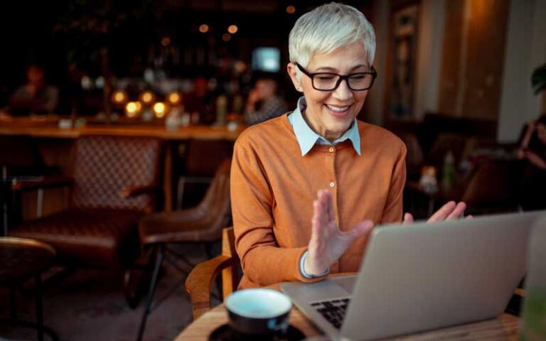 Smiling person in video call for addiction treatment at home support.