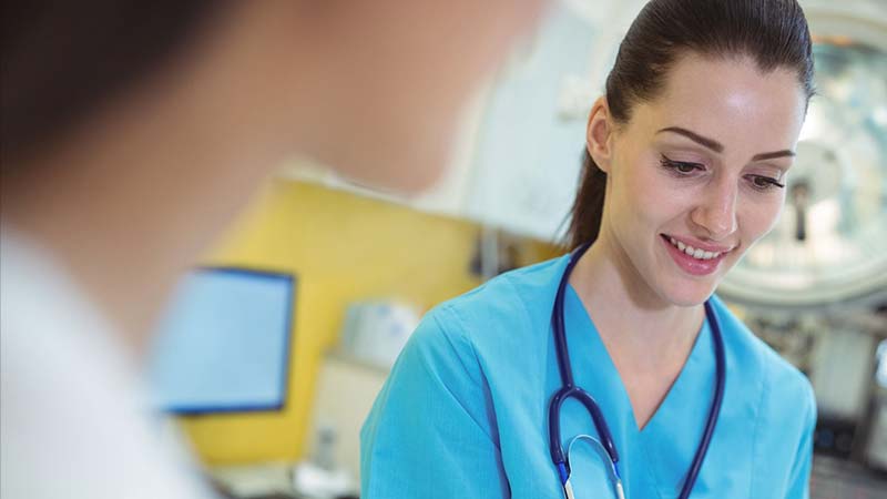Medical professional discussing addiction treatments in rehab program