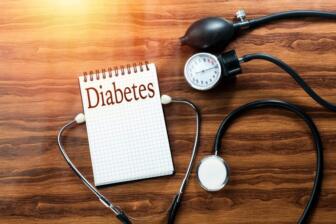 Stethoscope and blood pressure gauge with diabetes note, alcohol link