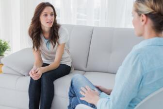 Two women discussing alcohol recovery in therapy session