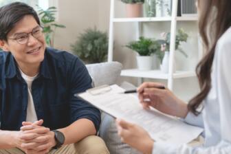 Man discussing recovery goals with therapist in a counseling session.