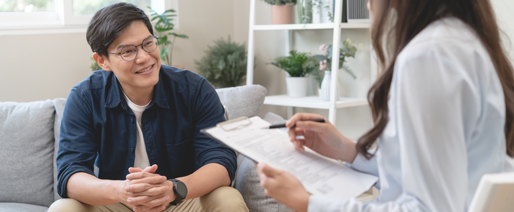 Man discussing recovery goals with therapist in a counseling session.