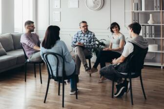Diverse group in discussion, alcohol rehab Bognor Regis support