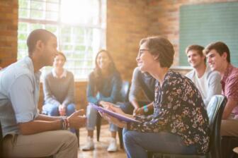 Group therapy session at alcohol rehab Morecambe with smiling participants
