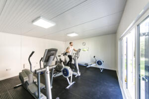 Individual exercising on bike in rehab gym, Alcohol Rehab Surrey facility