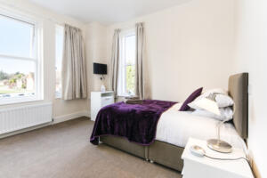 Bright, cozy bedroom in Alcohol Rehab Surrey center with natural light
