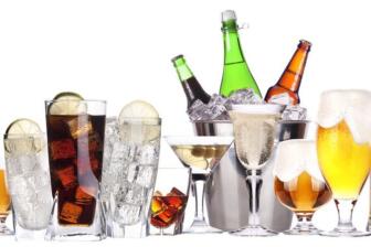 Assorted alcoholic beverages on white background, representing sobriety challenge.