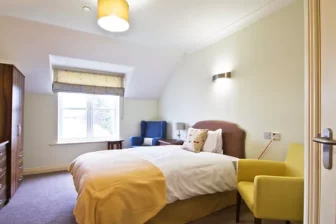 Bright rehab room with cozy bed and window for alcohol recovery