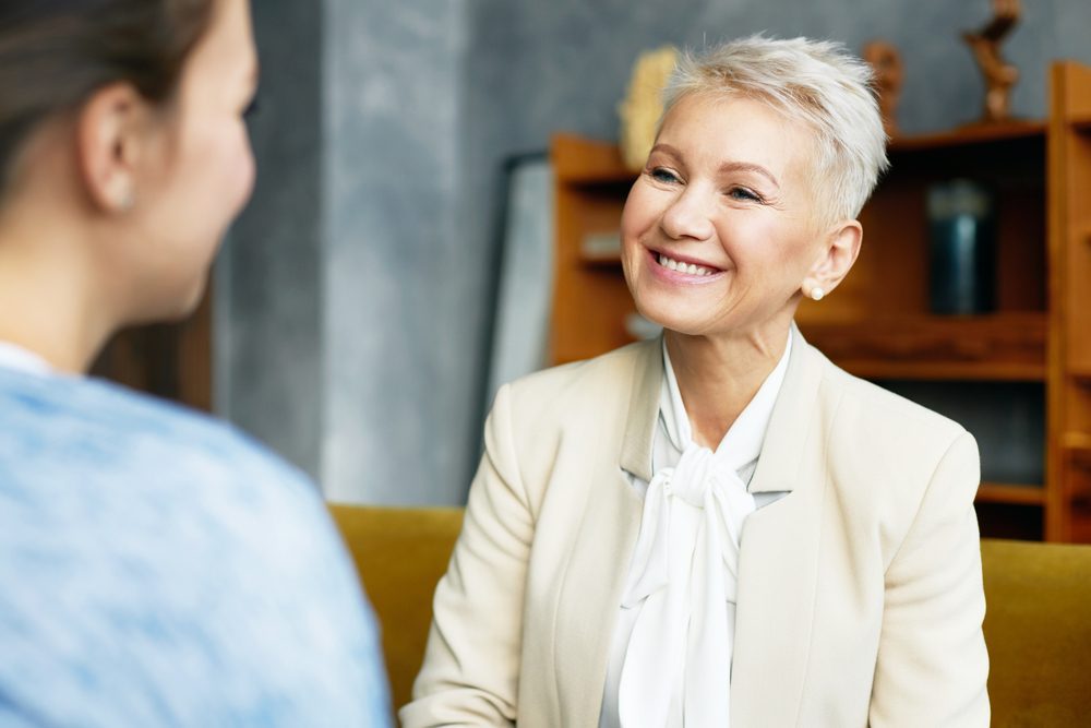 Smiling counselor talking with someone about quitting alcohol