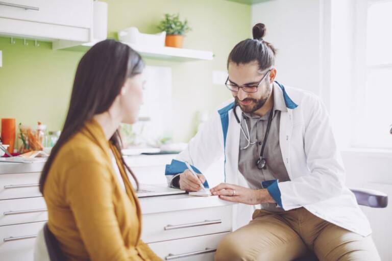 Doctor advising patient on alcohol recovery options in clinic