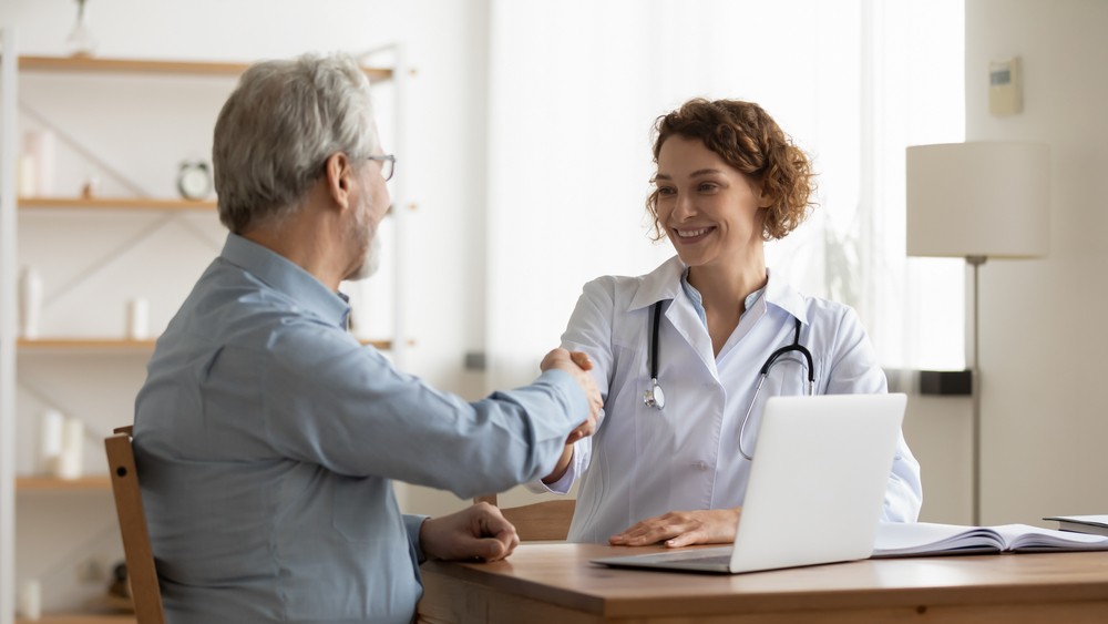 Doctor and patient handshake, addiction recovery consultation