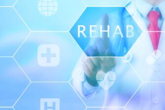 Doctor pointing at rehab icon, symbolizing alcohol recovery programs