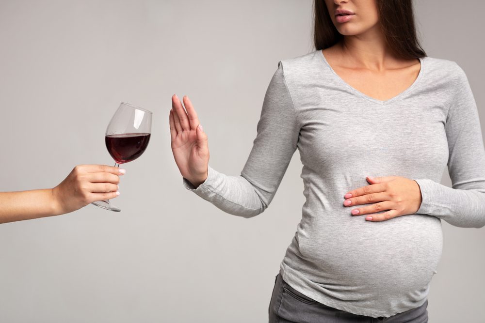 Pregnant woman refusing wine to prevent foetal alcohol syndrome