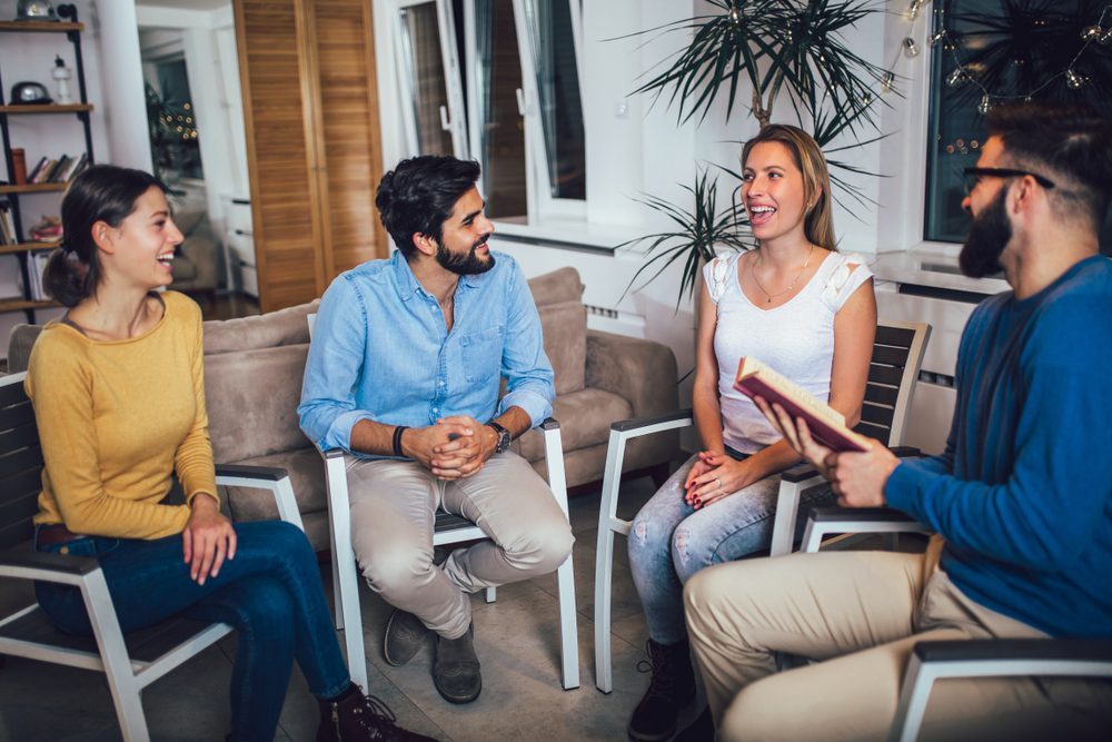 Group of people in a therapy session discussing alcohol recovery