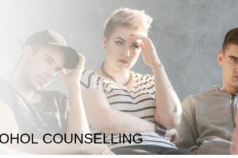 Group therapy session for alcohol recovery with three attentive participants