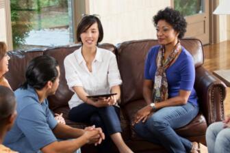 Diverse group in therapy session, discussing alcohol recovery