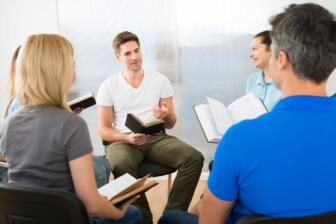 Group discussing alcohol recovery in supportive therapy setting