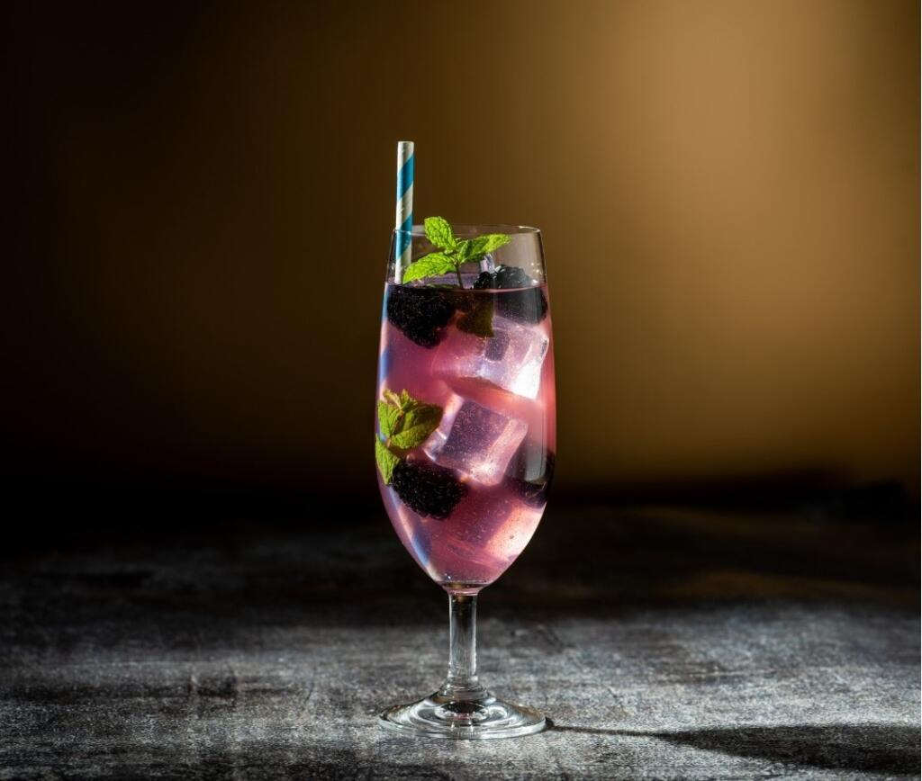 Glass of non alcoholic beer with berries and mint for an alcohol-free lifestyle