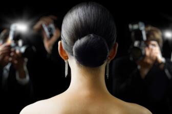 Woman facing photographers, representing pressure in alcohol recovery journey
