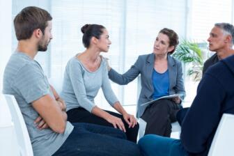 Support group meeting discussing alcohol recovery, rehab Wythenshawe