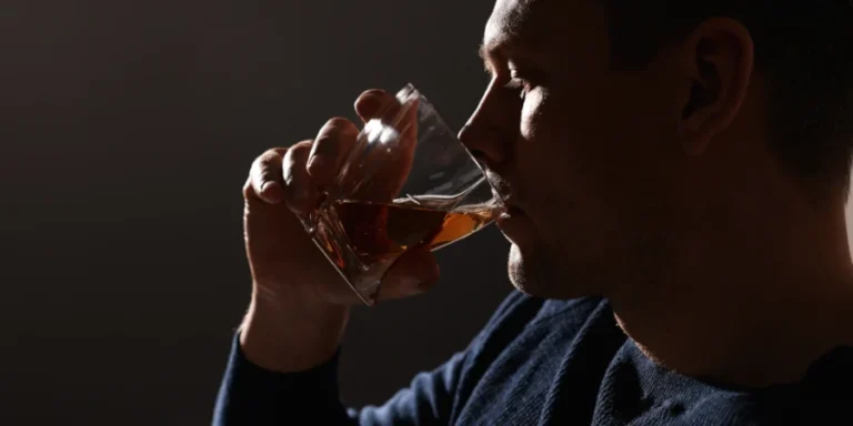 Profile of a person secretly drinking alcohol in dim light