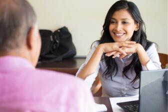 Woman counselor smiling during alcohol recovery consultation