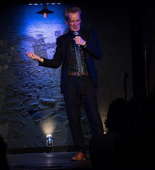 Comedian performing on stage, sober celebrities inspire recovery