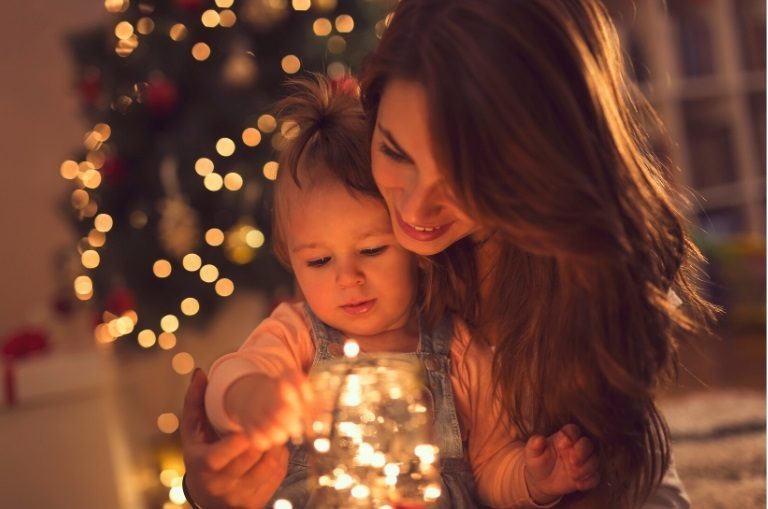 Mother and child enjoying a sober Christmas with festive lights.