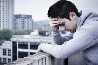 Young man in distress contemplating alcohol recovery
