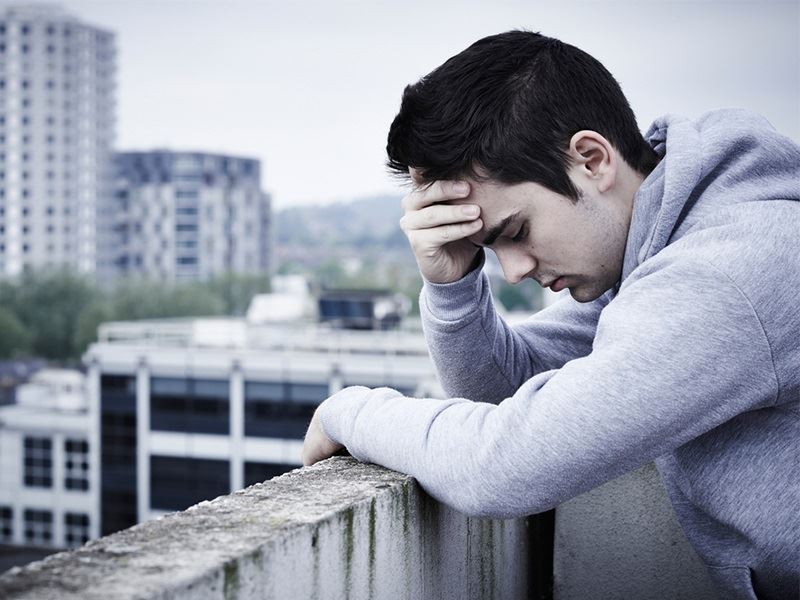Young man in distress contemplating alcohol recovery