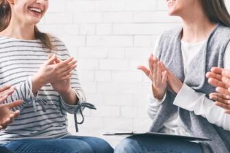 Support group clapping, encouraging alcohol recovery progress