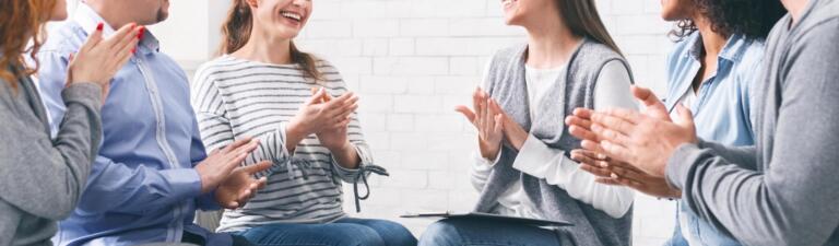 Support group clapping, encouraging alcohol recovery progress