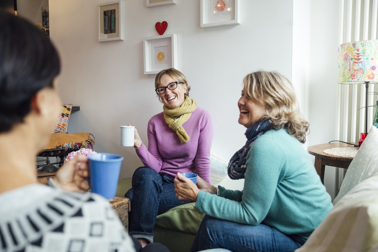 Women in cozy living room discussing alcohol recovery