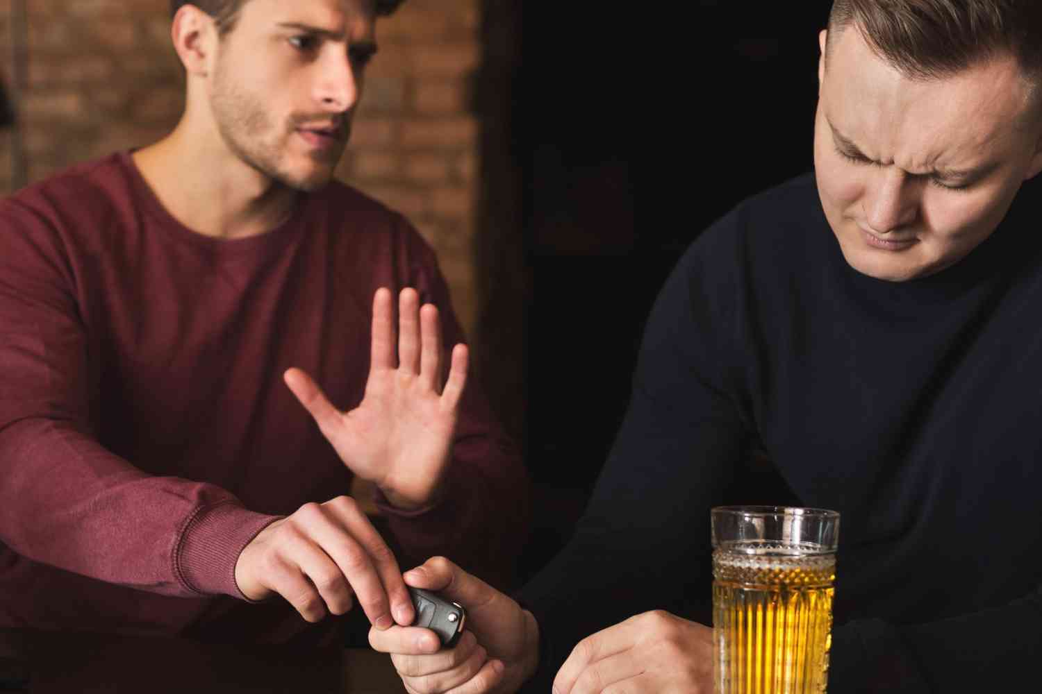 Two men discussing help for alcoholic friend at bar
