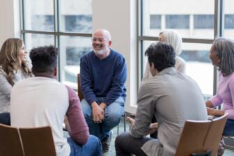 Group therapy session for alcohol recovery with diverse participants