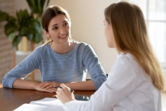 Two women in a supportive counseling session for alcohol recovery