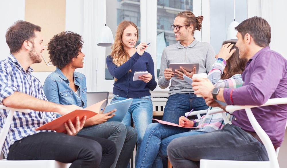 Diverse group discussing alcohol rehab strategies in a meeting