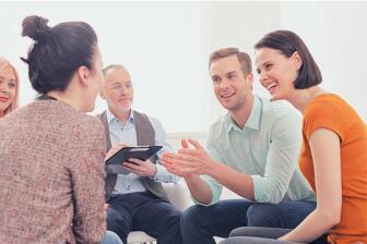 People in a supportive group therapy session discussing alcohol recovery