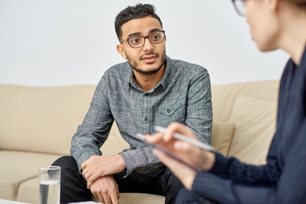 Man in therapy session discussing alcohol recovery program