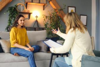 Two women in a therapy session for alcohol addiction recovery support