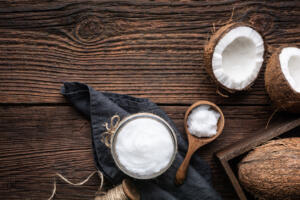 Coconut oil and coconuts on wooden table for alcohol withdrawal nutrition