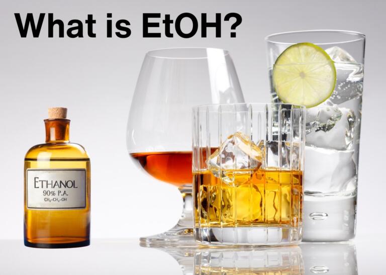 Image of whiskey, glass, lime, and ethanol bottle, illustrating what is ethanol.