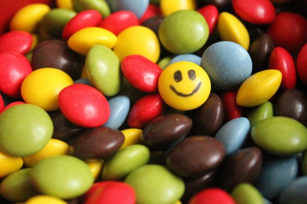 Smiley candy among colorful sweets, symbolizing joy in alcohol rehab