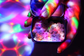 Hand holding MDMA pills, highlighting risks for alcohol rehab