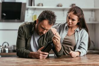 A supportive partner helps a man struggling with alcohol rehab