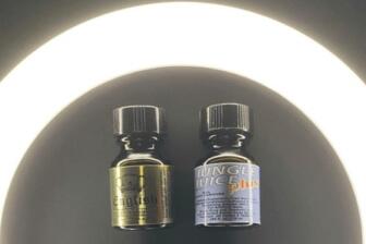 Two small poppers bottles with labels under bright light